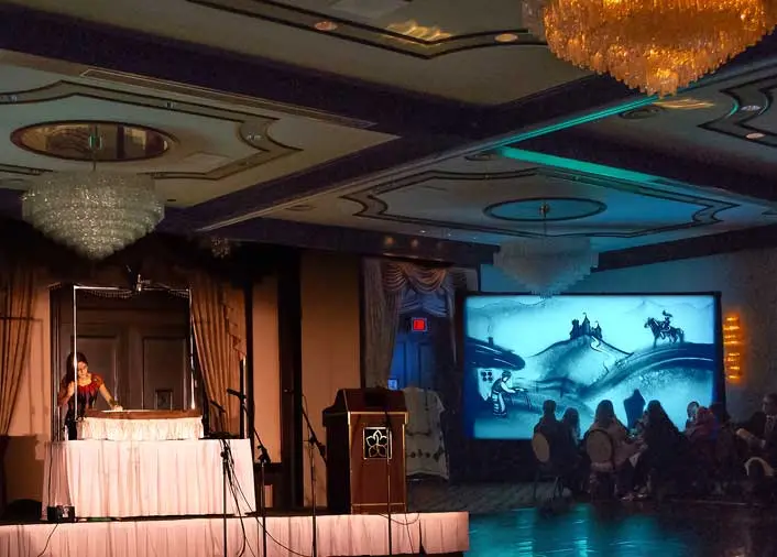 Sand painting artist Daria Tym at the official embassy opening event in Edmonton