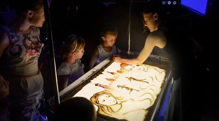 Daria Tym creating a personalized love story animation to book live sand art show for wedding celebrations.