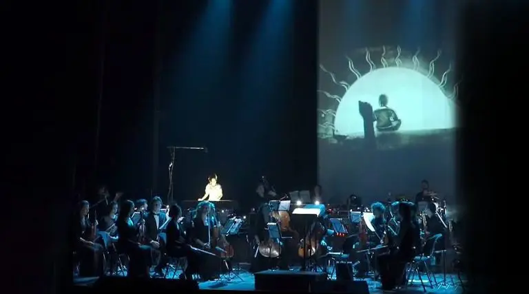 Artist performing a live sand show for music concert with Lords of the Sound orchestra at the Lviv National Opera.