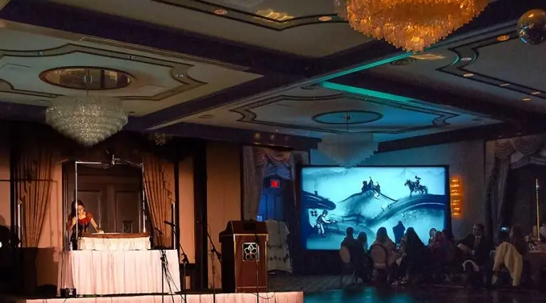 Professional sand animation artist performing a custom story for a wedding and corporate event for the Ukrainian Embassy in Edmonton.